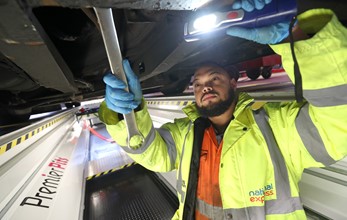 National Express West Midlands' new Perry Barr bus depot - engineer working on a bus in pit area
